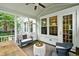 Covered outdoor porch with seating and natural views through the screens at 1407 Wando View St, Daniel Island, SC 29492