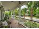 Inviting front porch featuring comfortable seating and a view of the palm tree-lined street at 1407 Wando View St, Daniel Island, SC 29492
