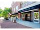 Charming storefront with brick facade, open door, and sidewalk seating inviting customers to enjoy the cafe at 1407 Wando View St, Daniel Island, SC 29492