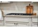 Granite countertop with cooktop and wooden accents at 1407 Wando View St, Daniel Island, SC 29492