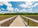 Scenic wooden bridge across marshland under a partly cloudy sky at 1407 Wando View St, Daniel Island, SC 29492
