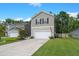 Two-story home with a two-car garage, a well-maintained lawn, and a concrete driveway in a residential area at 141 Lagoona Dr, Summerville, SC 29483