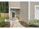 Charming front entrance with a decorative door, landscaping, and manicured garden with white rocks at 141 Lagoona Dr, Summerville, SC 29483