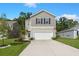 Charming two-story home featuring a wide driveway, two-car garage, and a mix of siding and stone accents at 141 Lagoona Dr, Summerville, SC 29483