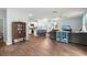 Open living room and kitchen area with wood floors, gray sectional, blue kitchen island, and a display cabinet at 141 Lagoona Dr, Summerville, SC 29483