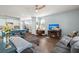 Spacious living room with wood floors, a gray sectional sofa, kitchen island, and a TV with a fireplace at 141 Lagoona Dr, Summerville, SC 29483