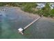 Tranquil water view with a long wooden pier extending into the marsh at 1439 Rivers Cotton Rd, Charleston, SC 29412
