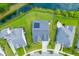 Aerial top shot shows solar panels on a house roof in a community near pond and greenery at 1439 Rivers Cotton Rd, Charleston, SC 29412