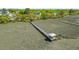 Aerial view of a dock extending into marshy area, featuring a covered area at the end at 1439 Rivers Cotton Rd, Charleston, SC 29412