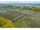 Scenic waterfront featuring multiple docks extending into the marsh with colorful homes nearby at 1439 Rivers Cotton Rd, Charleston, SC 29412