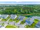Aerial view of homes backing onto a pond with lush green surroundings in a suburban neighborhood at 1439 Rivers Cotton Rd, Charleston, SC 29412
