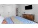 Bright bedroom features a large closet, mid-century modern dresser, and hardwood floors at 1439 Rivers Cotton Rd, Charleston, SC 29412