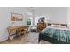 Cozy bedroom with a writing desk, chair, a dresser, neutral walls, and a large window at 1439 Rivers Cotton Rd, Charleston, SC 29412
