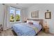 Bright bedroom with large windows, stylish decor and a comfortable bed with blue patterned bedding at 1439 Rivers Cotton Rd, Charleston, SC 29412