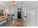 Inviting entryway with hardwood floors, board and batten walls, console table and stylish decor at 1439 Rivers Cotton Rd, Charleston, SC 29412