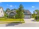 Inviting two-story gray home with well-maintained lawn, mature landscaping, and a convenient two-car garage at 1439 Rivers Cotton Rd, Charleston, SC 29412