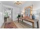 Bright foyer with stylish decor, a wooden console table, and a glimpse into the living area at 1439 Rivers Cotton Rd, Charleston, SC 29412