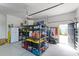 Organized garage with storage shelves, a fridge, and easy access to the outdoors at 1439 Rivers Cotton Rd, Charleston, SC 29412