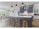Kitchen with gray island, white countertop, pendant lighting, and breakfast bar, conveniently located near the dining area at 1439 Rivers Cotton Rd, Charleston, SC 29412