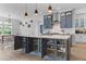 Kitchen island with gray cabinets, white countertops, pendant lights, barstool seating, and storage shelves at 1439 Rivers Cotton Rd, Charleston, SC 29412