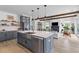 Open kitchen featuring blue cabinets, a large island, white countertops, stainless steel appliances, and views of living area at 1439 Rivers Cotton Rd, Charleston, SC 29412