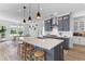Modern kitchen with dark gray cabinets, stainless steel appliances, and island seating at 1439 Rivers Cotton Rd, Charleston, SC 29412