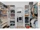 Walk-in closet featuring built in shelves and clothing racks and an attached laundry area at 1439 Rivers Cotton Rd, Charleston, SC 29412