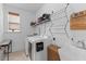 Bright laundry room with sink, drying rack, woven hamper and modern washer and dryer at 1439 Rivers Cotton Rd, Charleston, SC 29412