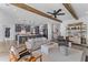 Stylish living room showcasing wood beam ceilings, a gray sofa and an open kitchen at 1439 Rivers Cotton Rd, Charleston, SC 29412