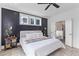 Bedroom with hardwood floors, dark accent wall behind the bed, ensuite bathroom with soaker tub and shower at 1439 Rivers Cotton Rd, Charleston, SC 29412