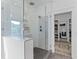 Modern glass enclosed shower with tiled walls and a view to the backyard at 1439 Rivers Cotton Rd, Charleston, SC 29412