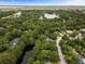 Beautiful aerial view of a community with lush trees, a pond and glimpses of the bay in the distance at 1478 Diamond Blvd, Mount Pleasant, SC 29466