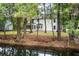 Backyard view of the home, showing pond, trees, and exterior at 1478 Diamond Blvd, Mount Pleasant, SC 29466