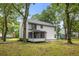 Backyard view of the home showing covered patio and surrounding trees at 1478 Diamond Blvd, Mount Pleasant, SC 29466
