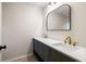 Elegant bathroom with double sinks, sleek gold fixtures, and a modern, arched mirror at 1478 Diamond Blvd, Mount Pleasant, SC 29466