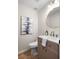 Stylish powder room featuring a modern vanity, toilet, and a decorative gold-trimmed mirror at 1478 Diamond Blvd, Mount Pleasant, SC 29466