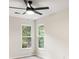 Bright bedroom features wood floors, two windows overlooking greenery, and a ceiling fan at 1478 Diamond Blvd, Mount Pleasant, SC 29466