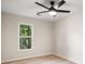 Bright bedroom with wood floors, a ceiling fan, and a large window overlooking greenery at 1478 Diamond Blvd, Mount Pleasant, SC 29466