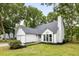 Charming home featuring a well-manicured lawn, lush trees, and a classic white exterior at 1478 Diamond Blvd, Mount Pleasant, SC 29466