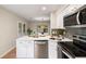 Modern kitchen with stainless steel appliances, a quartz countertop island, and a view of the dining area at 1478 Diamond Blvd, Mount Pleasant, SC 29466