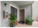 Inviting condo entrance with green plants, olive green siding, and a modern light fixture. The door number is displayed at 1481 Center Street Extension # 1102, Mount Pleasant, SC 29464