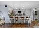 Open kitchen with stainless steel appliances, breakfast bar, and wood floors at 1481 Center Street Extension # 1102, Mount Pleasant, SC 29464