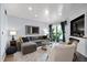 Cozy living room features neutral tones, comfortable seating, and a sliding glass door to a private balcony at 1481 Center Street Extension # 1102, Mount Pleasant, SC 29464