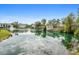 A serene pond surrounded by lush greenery and residential buildings at 1481 Center Street Extension # 1102, Mount Pleasant, SC 29464