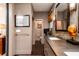 Contemporary bathroom with dual sinks, dark countertops, modern fixtures, and stylish hexagon tile floor at 1646 Marsh Harbor Ln, Mount Pleasant, SC 29464