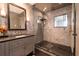 Sleek bathroom features gray tiled walls, shower with glass, and vanity with dark countertop at 1646 Marsh Harbor Ln, Mount Pleasant, SC 29464