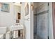Stylish bathroom with a marble sink, glass shower, and gold fixtures at 1646 Marsh Harbor Ln, Mount Pleasant, SC 29464