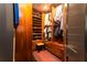 Custom walk-in closet with built-in shelving, drawers, shoe racks, and a plush bench at 1646 Marsh Harbor Ln, Mount Pleasant, SC 29464