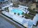 Aerial view of a stunning community pool with palm trees, lounge seating, and a cabana area at 165 Country Gate Ln, Summerville, SC 29485