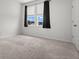 Carpeted bedroom with window and view of lush, green neighborhood at 165 Country Gate Ln, Summerville, SC 29485